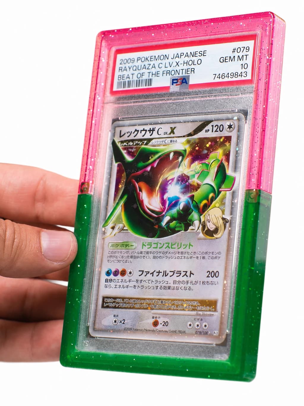 A collector holding a Rayquaza card in a pink and green SnapGard